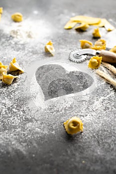 Heart drawn from flour on a stone table