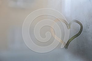 Heart drawn on foggy window, space for text. Rainy weather