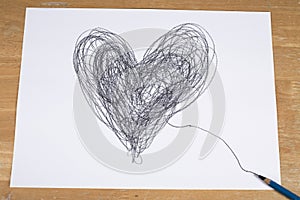 Heart drawn by pencil on paper sheet