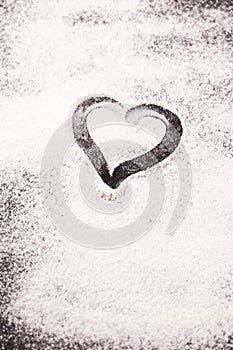 Heart drawn in scattered flour