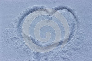 Heart drawn on the snow, winter cold weather. Love despite snowfall and cold. Tender feelings squabble a blizzard