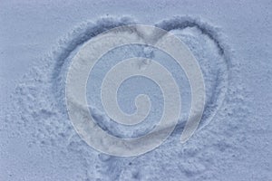 Heart drawn on the snow, winter cold weather. Love despite snowfall and cold. Tender feelings squabble a blizzard photo