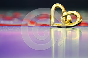 Heart earring on the floor with reflection