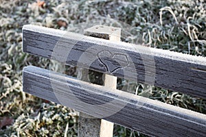 Heart engraved on a frozen bench