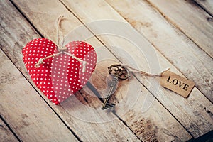 Heart fabric and vintage key with tag label LOVE on wood table b