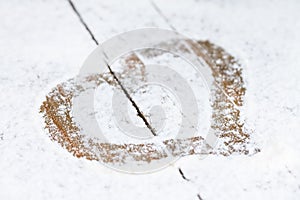 Heart of flour on wooden table