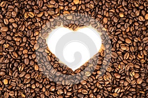 Heart formed by coffee beans on wood