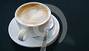 Heart froth of latte hot coffee, Love foam in a white cup, Close up.