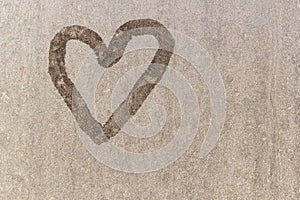 Heart on frozen glass. Ice on a window background. Big warm