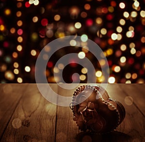 Heart gift on wooden plank under shinning light