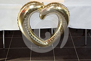 Heart golden balloon on wedding table ceremonies at party