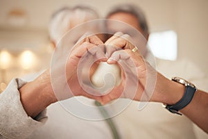Heart hands, emoji and senior couple in home with commitment, support and marriage in retirement together. Love sign