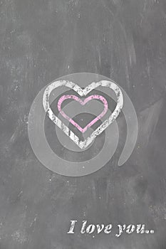 Heart and the inscription I love you on the chalk school blackboard children`s drawing. Valentine`s day card, love