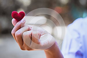 Heart knit in the hands of the girl.