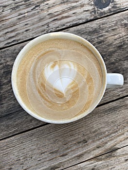 Heart latte art admired on a Nashville cafe table