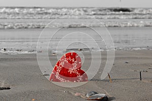 A heart left on the beach in summer