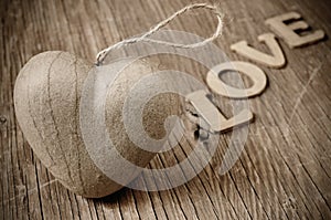 Heart and letters forming the word love, in sepia toning