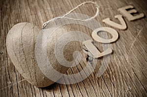 Heart and letters forming the word love, in sepia toning photo