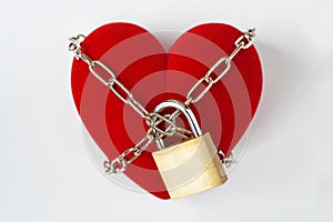 Heart locked with chain and padlock on white background - Concept of love