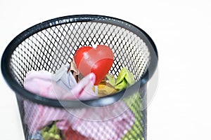 Heart lollipop in a basket full of colorful papers