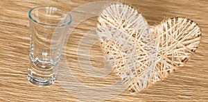 Heart made of bejeweled linen on a background of oak board photo