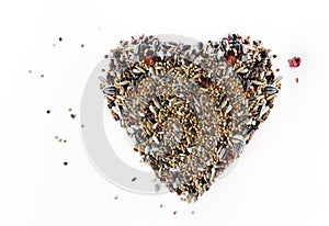 heart made of bird grain isolated on white background