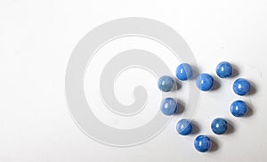 heart made of blue beads isolated on a white background. World Heart Day. love, donation, family insurance
