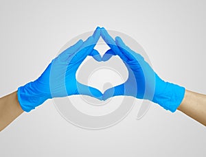 Heart made blue nitrile glove. Medic`s hands, covid