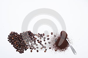 Heart made of coffee beans and spoon ground coffee isolated on white background