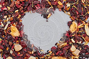 Heart made of dried hibiscus tea with fruits.