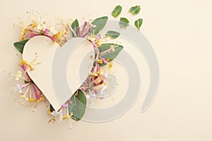 Heart made from lonicera periclymenum belgica flowers photo