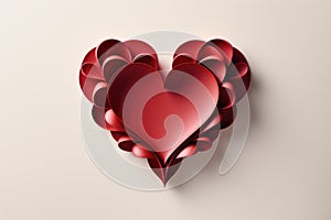 A heart made out of red paper on a white surface.