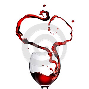 Heart made of pouring red wine in glass