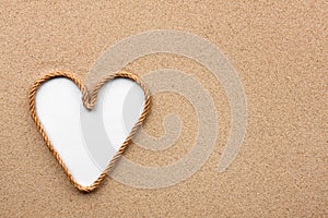 Heart made of rope with a white background on the sand