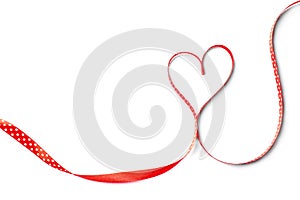 Heart made of satin ribbon on white background