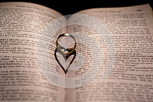 A heart made from the shadow of a ring on a book