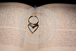 A heart made from the shadow of a ring on a book