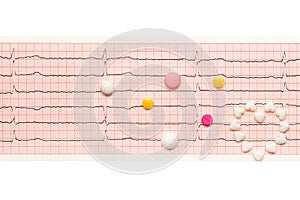 Heart made of tablets and tablets on paper ECG results