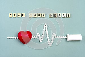 Heart, medical pills in the form of cardiogram, capsules on gray background