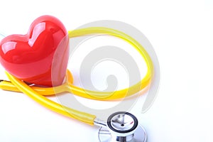 Heart with a medical stethoscope, isolated on wooden background