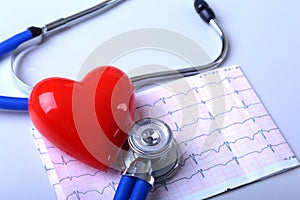 Heart with medical stethoscope on the paper cardiogram