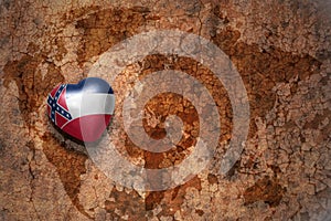 Heart with mississippi state flag on a vintage world map crack paper background