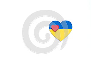 Heart with national flag colors of Ukraine as a symbol of patriotism, pride in one`s country. Smaller red heart in middle.