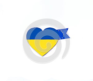 Heart with national flag colors of Ukraine and fabric ribbons with flag of European Union on white background.