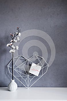 Heart with note on background of concrete wall. Symbol Valentine's Day