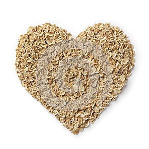 Heart of oat flakes close up on white background