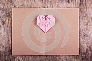 Heart origami and book with blank pages. Pink heart made of paper and diary