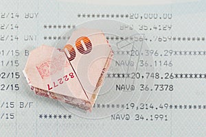 Heart origami foldingBaht bank note on opening equity fund account passbook