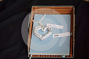 A blue journal with a heart ornament words on paper.