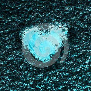 Heart painted on the snow-covered windshield of a car.